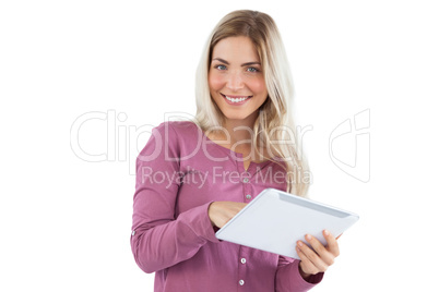 Smiling blonde woman using tablet pc