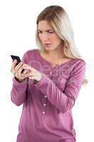 Worried woman sending text message