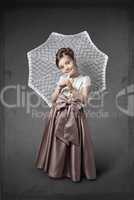 Girl in a luxurious dress with an umbrella