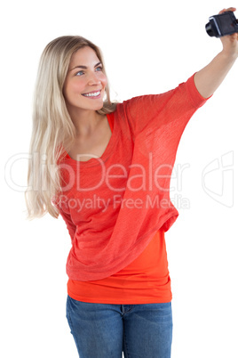 Smiling woman taking picture of herself