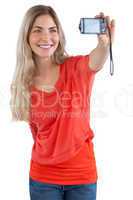 Smiling blonde woman taking picture of herself