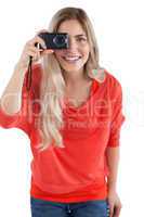 Blonde woman holding digital camera