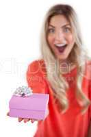 Astonished woman holding a gift