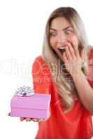 Surprised woman holding a present