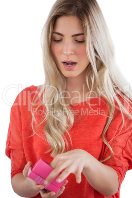 Surprised woman opening her gift