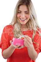 Blonde woman discovering necklace in a gift box