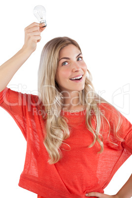 Woman holding light bulb above her head