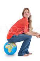 Woman sitting on a globe