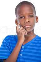 Thoughtful little boy with hand on face