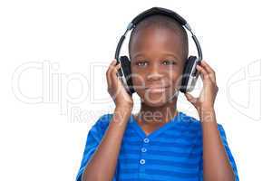 Smiling little boy listening to music