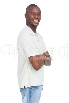 Smiling young man standing with arms crossed