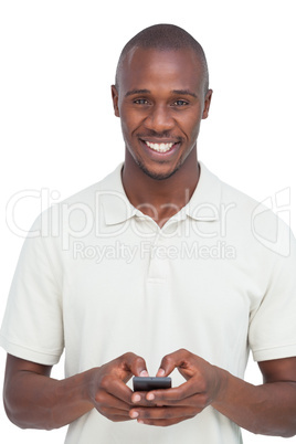 Smiling man using his mobile phone