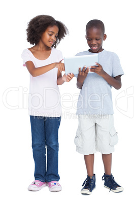 Brother and sister using tablet pc