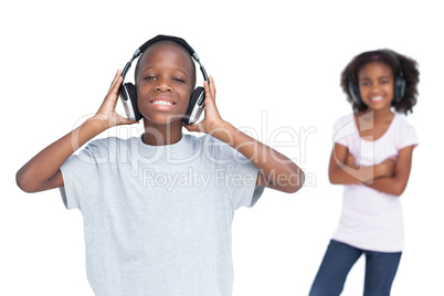 Brother and sister using headphones