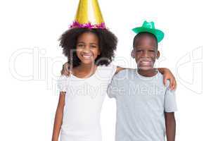 Brother and sister wearing party hats