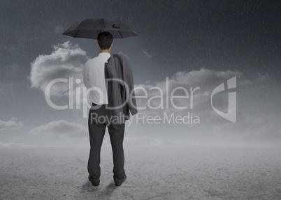 Rear view of a businessman holding an umbrella