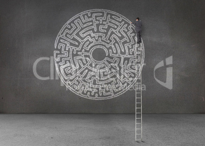Businessman drawing a labyrinth