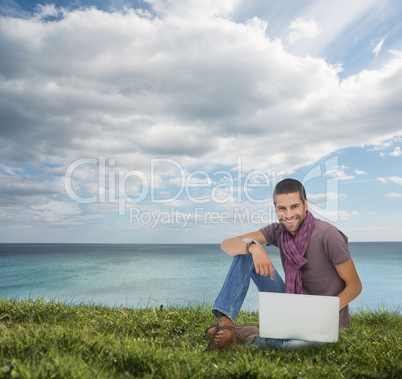 Handsome man sitting on the grass