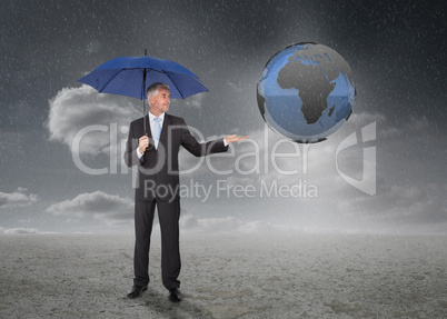 Businessman with blue umbrella