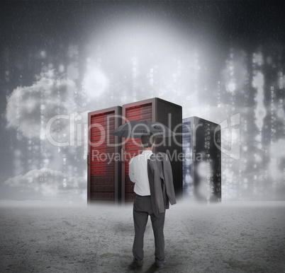 Businessman looking at red servers