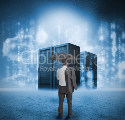 Businessman looking at blue servers