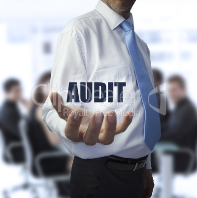 Smart businessman holding the word audit