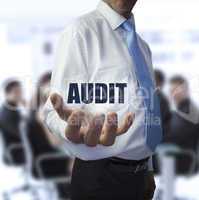 Smart businessman holding the word audit