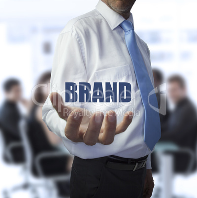 Smart businessman holding the word brand