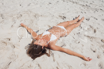 Sunbathing woman lying on beach