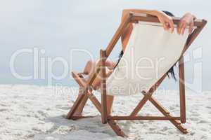 Woman lying on her deck chair