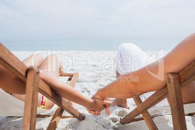 Couple resting on deck chairs