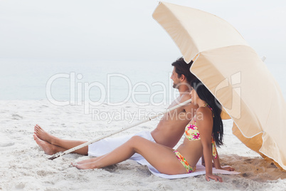 Couple lying on beach towel at the beach