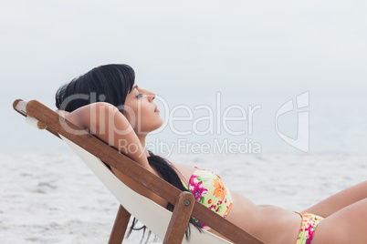 Beautiful woman sleeping on deck chair