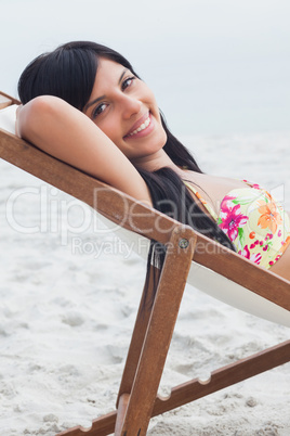 Beautiful woman resting on deck chair