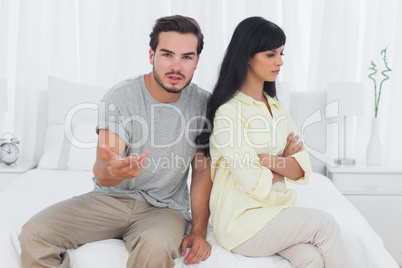 Woman sulking and her boyfriend doesnt know what to do