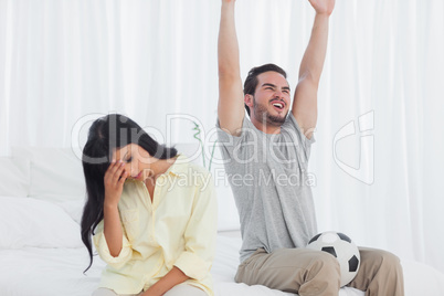 Woman annoyed at her partner watching football