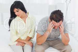 Woman sulking with boyfriend looking down during a fight