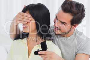 Happy man about to propose hiding eyes of his girlfriend