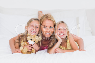 Portrait of woman in bed with her children