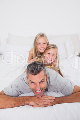Man giving a piggy back to his children