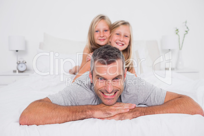 Portrait of a man giving a piggy back to his children
