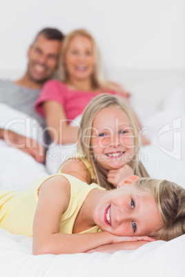 Cute twins posing in bed in front of their parents