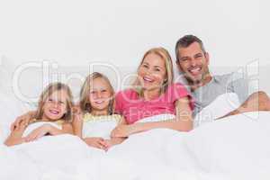 Portrait of a family lying in bed