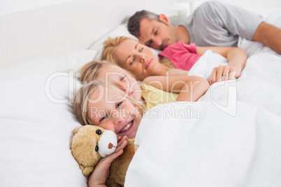 Parents sleeping with their daughters in bed