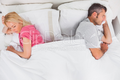 Upset couple lying back to back