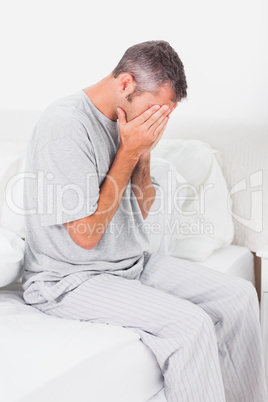 Worried man holding his head