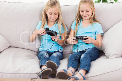 Cute twins playing video games together
