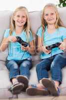 Young twins playing video games together