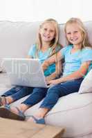 Cute twins using a laptop together