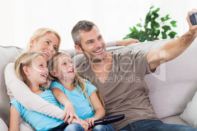Man taking picture of his children and wife